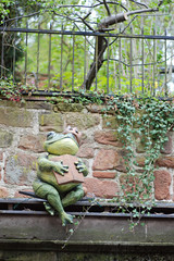 Frog King sitting near a garden