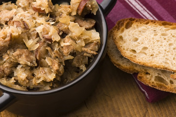 traditional polish sauerkraut (bigos) with mushrooms and plums