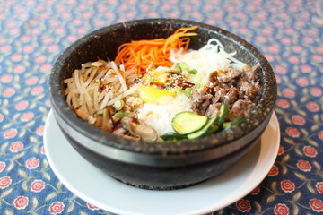 Bibimbap in a stone bowl at a Korean restaurant.