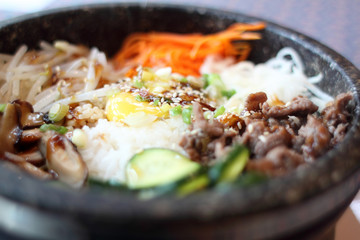 Bibimbap in a stone bowl at a Korean restaurant.