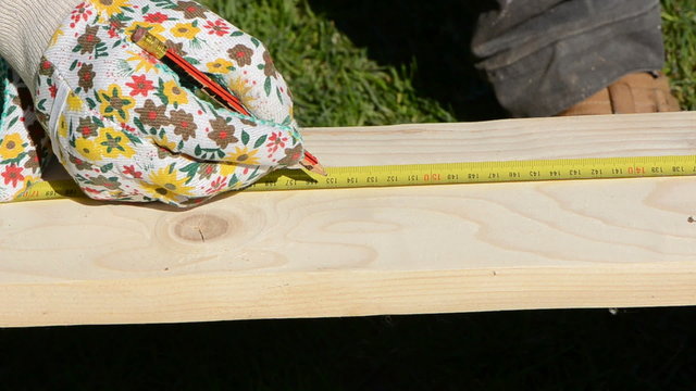carpentry measure wood plank and marking it with pencil