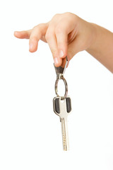 Fingers holding Golden key isolated over white