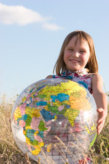 Happy girl with big globe