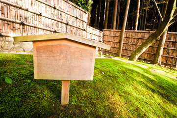 Japanese forest with bamboo fence and clear notice board
