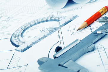 The plan industrial details, a protractor, caliper and a red pen