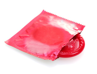 Red condom with  open packing isolated on white