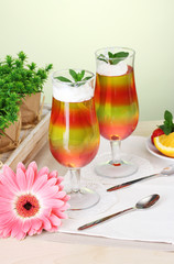 fruit jelly in glasses and fruits on table in cafe