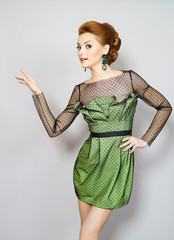 The young beautiful girl in a green dress