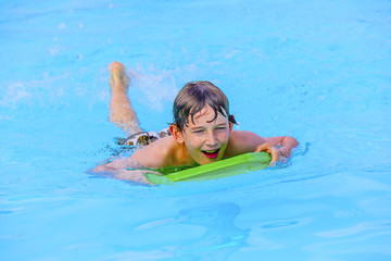 boy paddling on the surf board