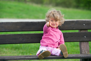 little girl is pointing in the camera