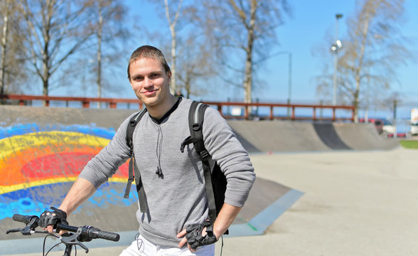 Portrait of BMX bicycle rider on urban skatepark background