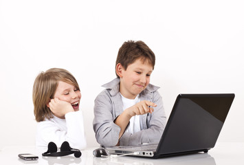 Two boys smiling and searching internet