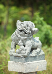 Fototapeta na wymiar Chinese Lion statue in Thai temple, Thailand