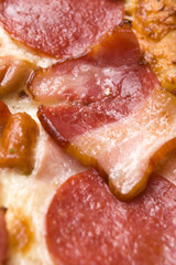 Italian pizza with bacon, salami and mozzarella cheese