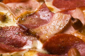 Italian pizza with bacon, salami and mozzarella cheese