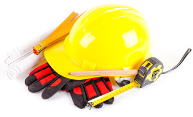 yellow hardhat, tools and construction plans