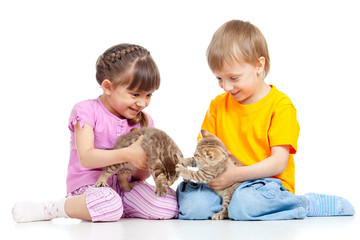 Fototapeta na wymiar Children boy and girl playing with kittens. Isolated on white ba