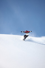 Man snowboarding down hill