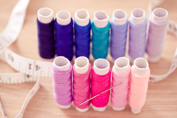 set of pink colorful sewing threads