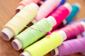 set of pink colorful sewing threads