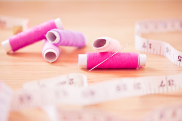 set of pink colorful sewing threads