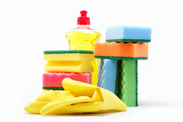 Detergent bottle, rubber gloves and cleaning sponge on a white b