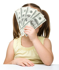 Cute little girl with dollars