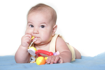 studio portrait of cute baby with toy over white