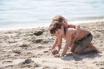 Fototapeta na wymiar two children playing on beach