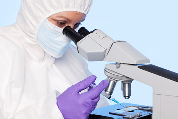 Embryologist extracting a sample using a syringe.
