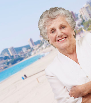 portrait of a adorable senior woman standing in the beach