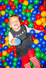 the child in the pool with balls