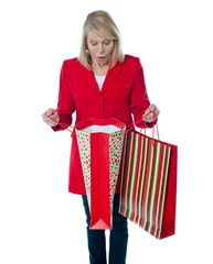 Fototapeta premium Lady surprised to see empty shopping bag