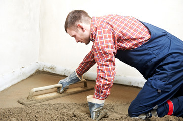 Plasterer concrete worker at floor work