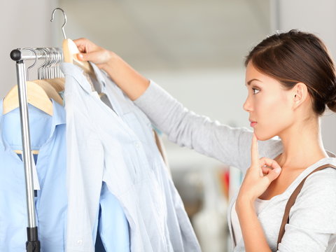 Shopper choosing clothes thinking