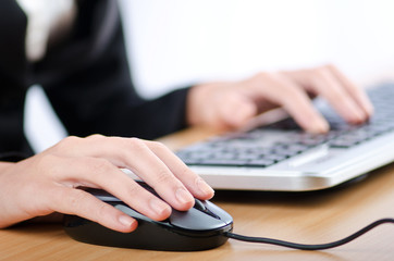 Hands typing on the keyboard
