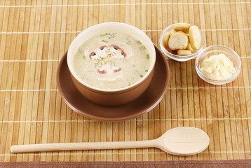 Tasty soup on wooden mat