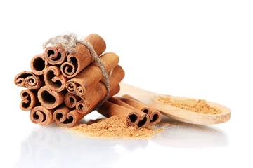 Poster Cinnamon sticks and powder in wooden spoon isolated on white © Africa Studio