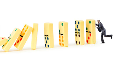 Businessman and dominoes isolated on the white