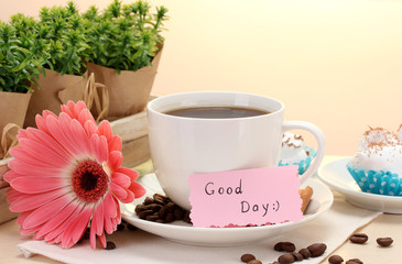 cup of coffee and gerbera beans, cinnamon sticks on wooden table