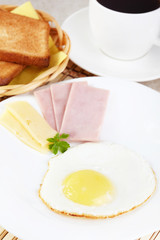 Breakfast. Fried eggs with cheese and ham