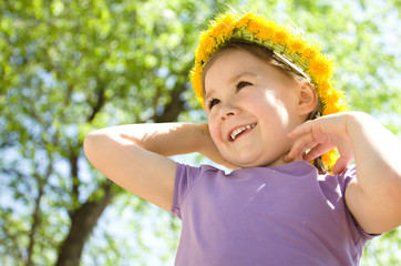 Portrait of a little girl with a wreath