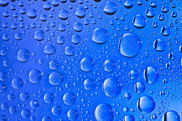 Blue water drops on the glass