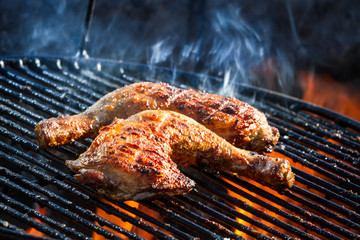 Fototapeta Flames frying chicken on the grill obraz