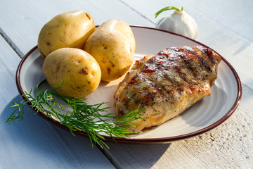 Roasted chicken served with potatoes and dill