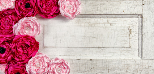 Pink vintage flowers on aged door