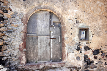 Fototapeta na wymiar A very worn and battered old blue door