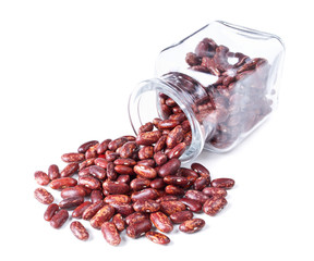 red speckled kidney beans scattered on a white background
