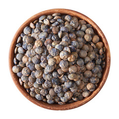 wooden bowl full of French lentils isolated on white
