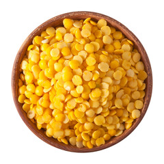 wooden bowl full of yellow split lentils isolated on white